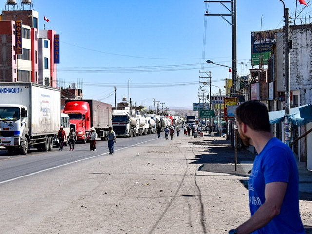 A long line of trucks standing still on the Pan American Highway.