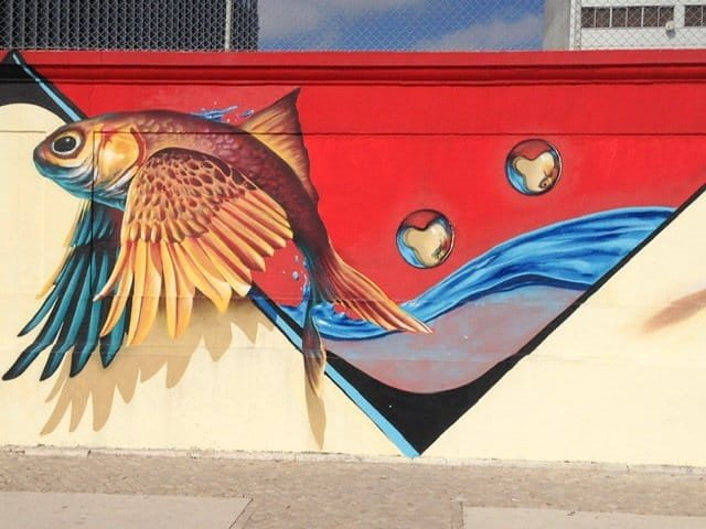 Mural of golden fish jumping out of water