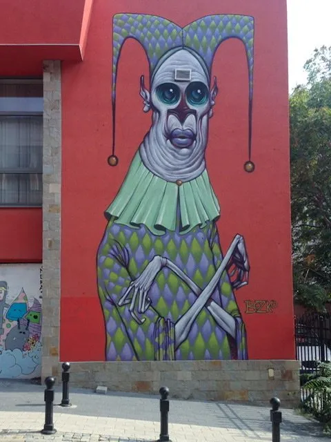 Mural of a creepy jester with skeleton arms