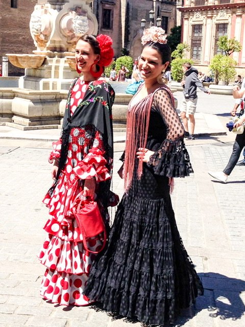 Two young women in traditional dress in Seville, Spain