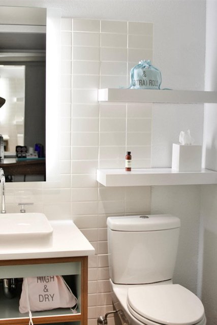 White floating shelves in pristine bathroom