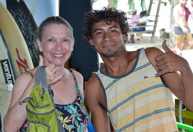 Man and woman throwing shaka sign