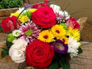 Basket of red, yellow, purple, and white flowers