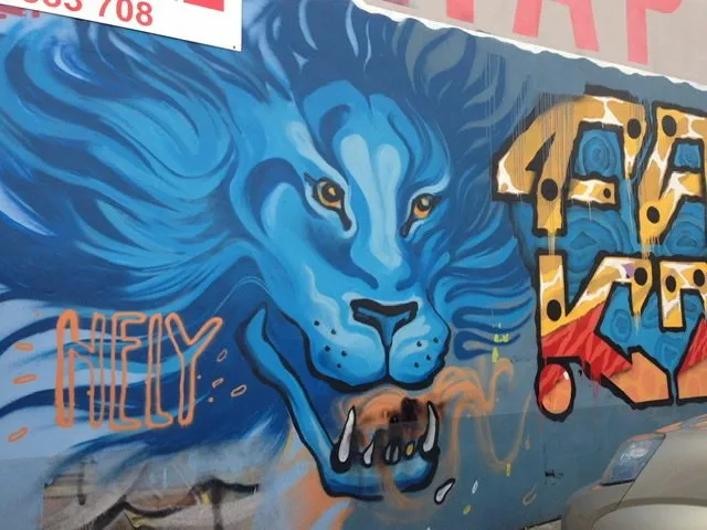 Mural of a blue lion with bared teeth