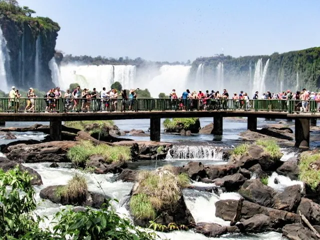 Crowds of people on a boardwalk at Iguazu Falls, Brazil