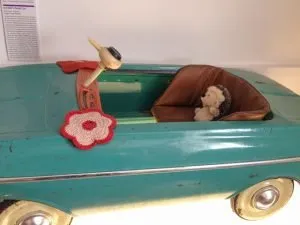 A toy hedgehog sitting in a toy car