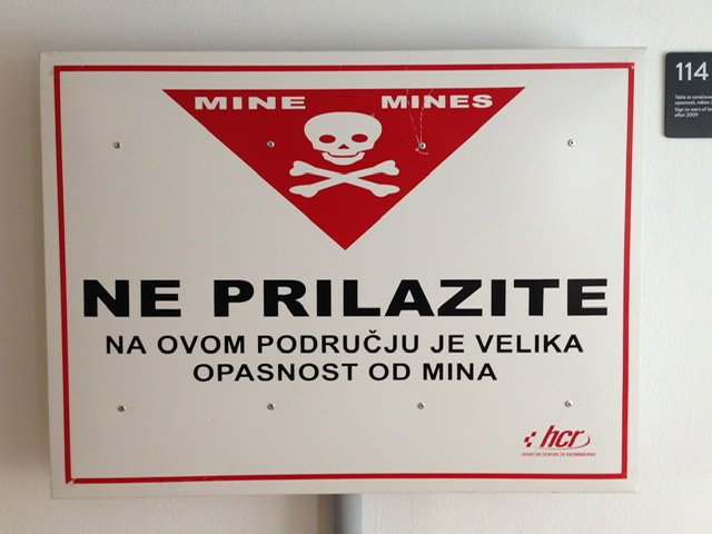 A sign warning of danger from mines in Croatian