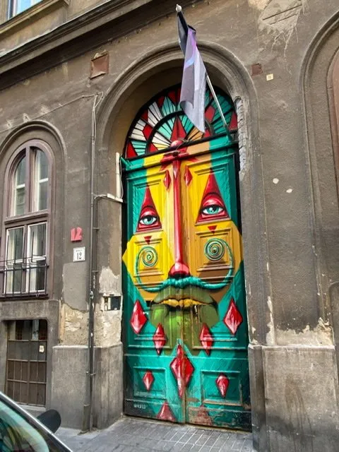 A door painted with a colorful and zany face