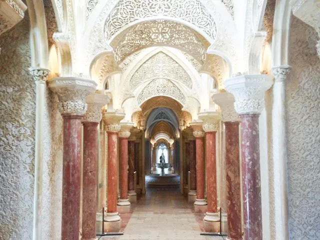 Hallway with marble columns and filigree details