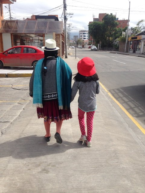 A woman in native clothing with a young girl