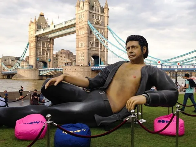 A large statue of Jeff Goldblum with the Tower Bridge in the background