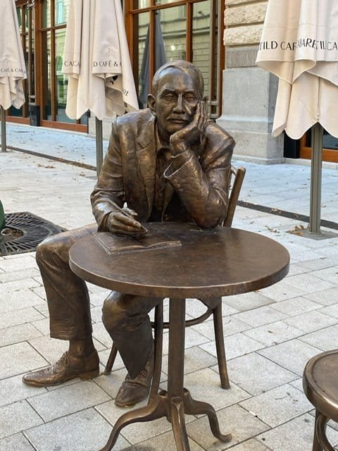 Statue of a man writing at a table