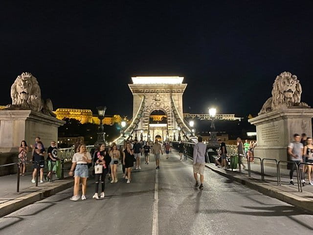 The Chain Bridge with pedestrians at night