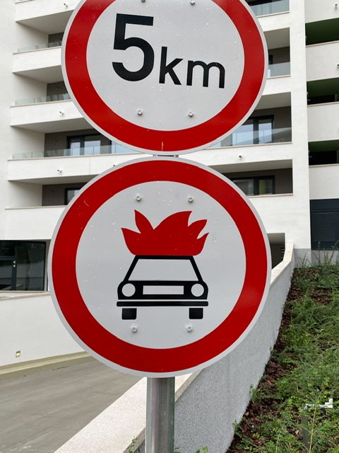 Traffic sign with a car on fire