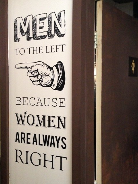 Sign directing men to the restroom