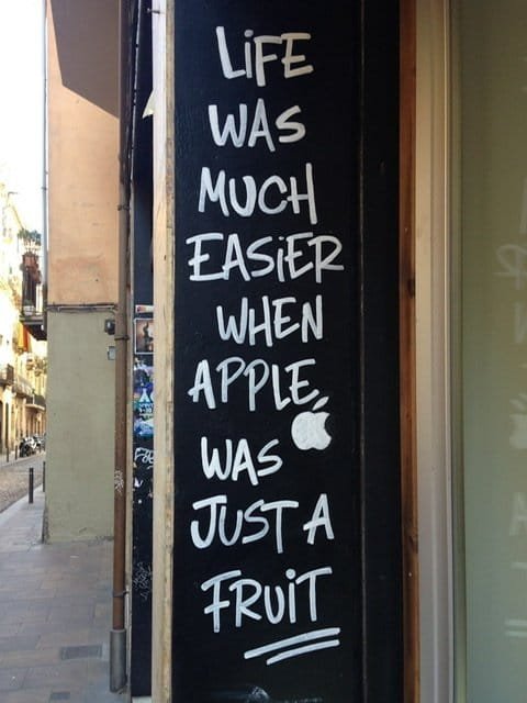 A sign reading “Life was much easier when apple was just a fruit.”