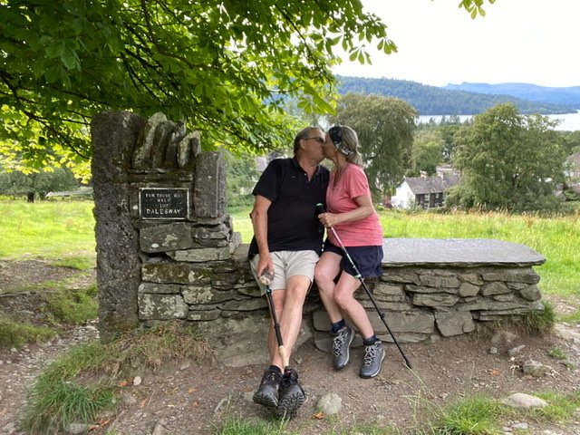 Man and woman kissing at the end of the Dales Way