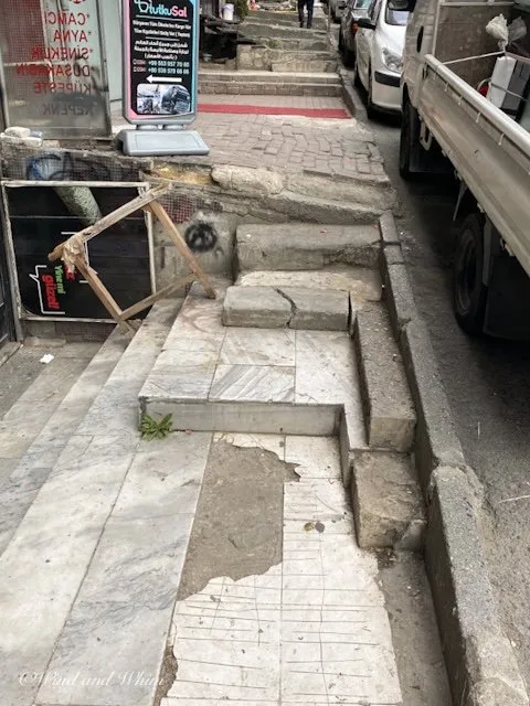 A sidewalk with many obstacles
