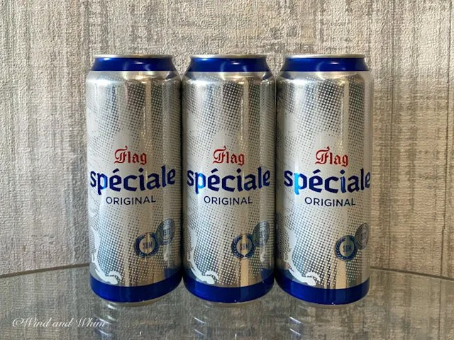 Three cans of Flag Speciale beer