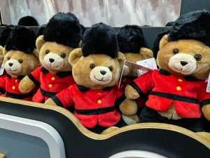 a group of stuffed bears in red and black uniforms