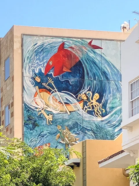 a mural with sea creatures and a giant wave