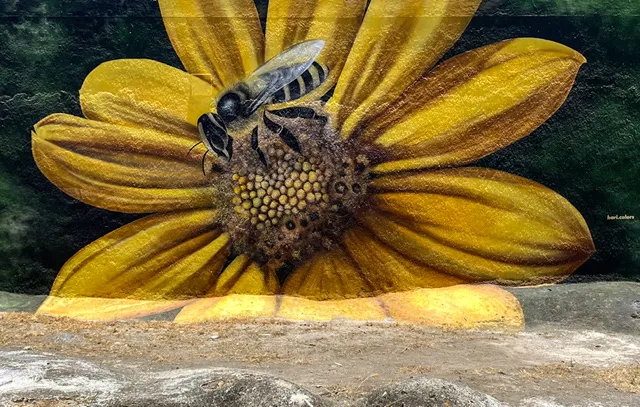 Painting of a bee on a yellow flower