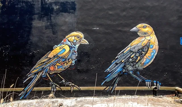a mural of mechanized birds on a wall