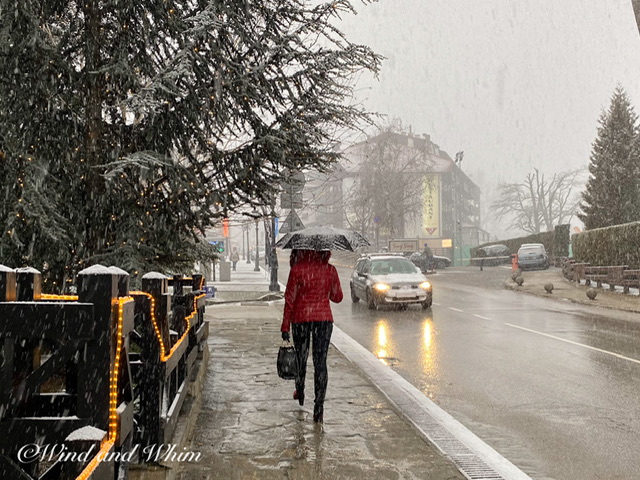 A woman walking through wet snow