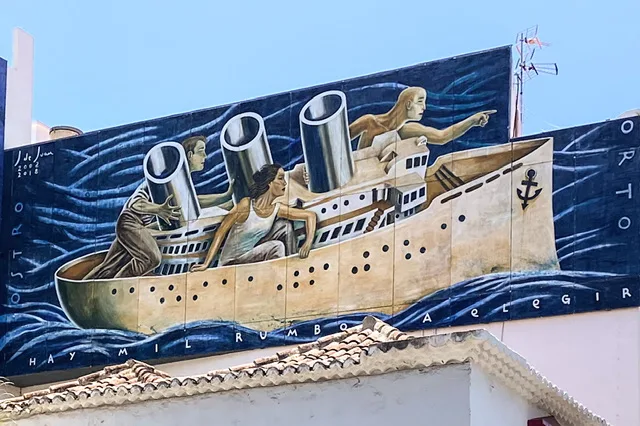 A mural of two women and a man in a boat