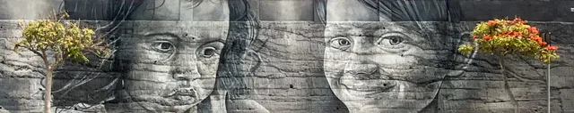 A mural of a girl and a boy with trees