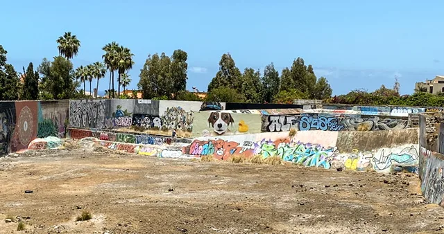 A variety of murals on an abandoned foundation