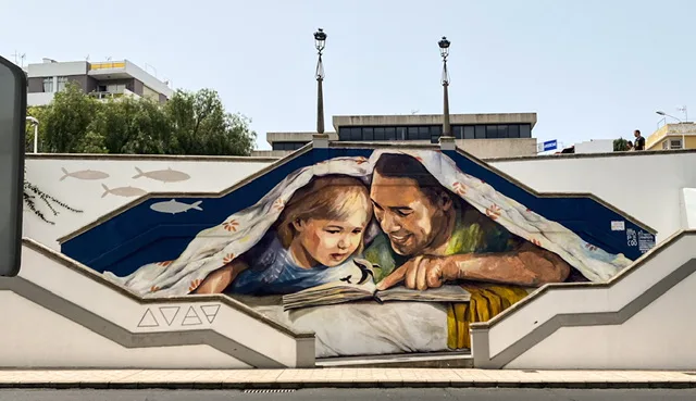 A Mural of a father reading to his son