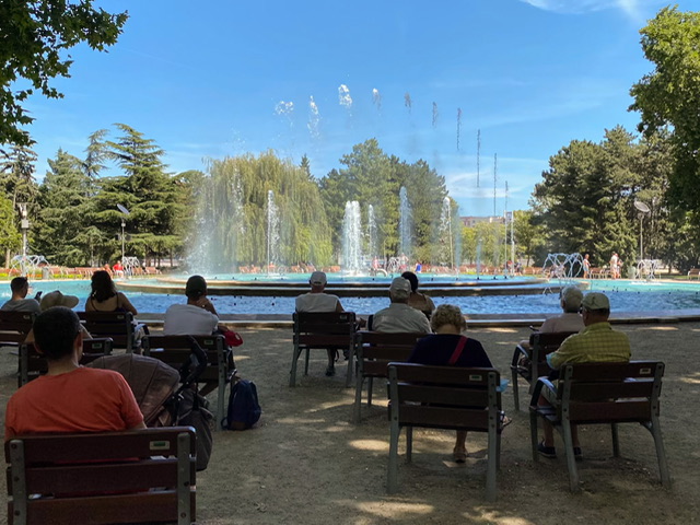 People in chairs looking at a large fountain