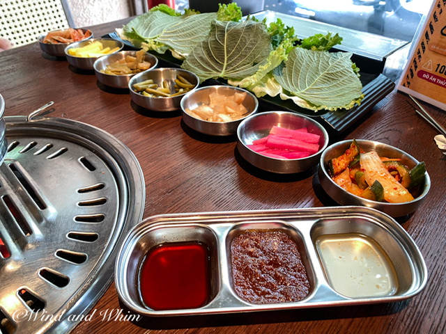 Sauces, relishes, and lettuce leaves on a table