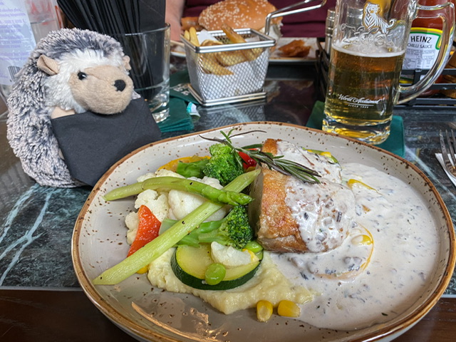 A plate of chicken, potatoes, and vegetables