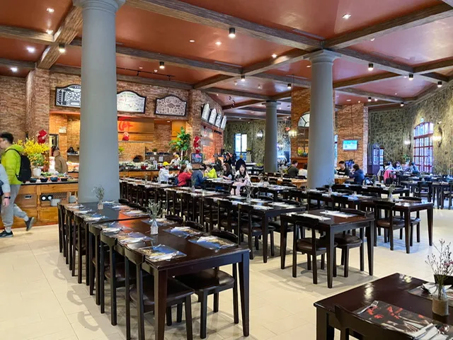 The inside of a buffet restaurant with long tables