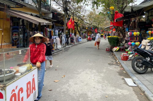 People walking on a street full of shops