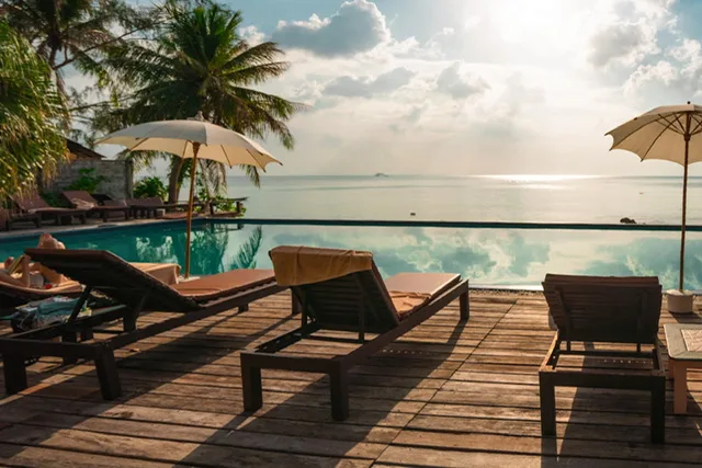 Loungers overlooking a pool and sea