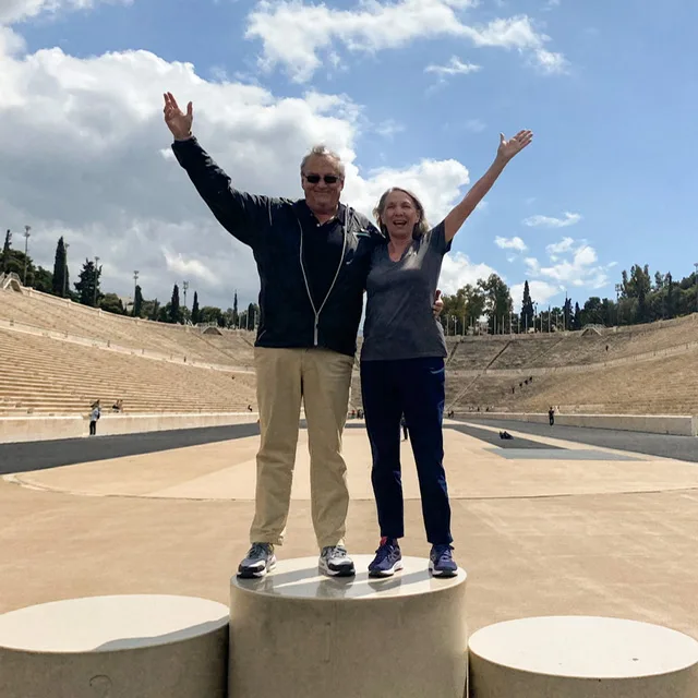 A man and woman standing on an Olympic podium