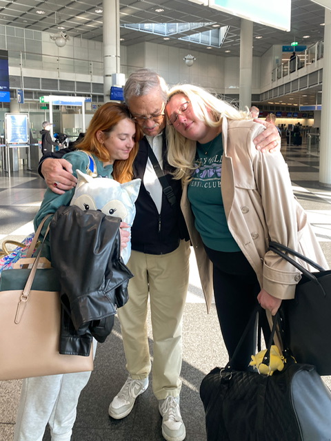 Three people in a hug