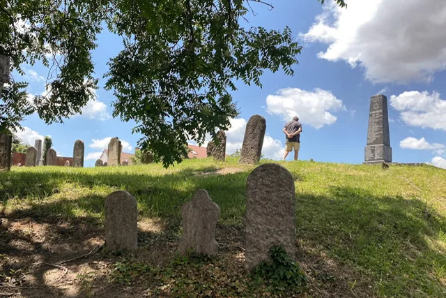 A man standing in a cemetery