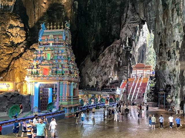 A Hindu temple and a long staircase inside a cave