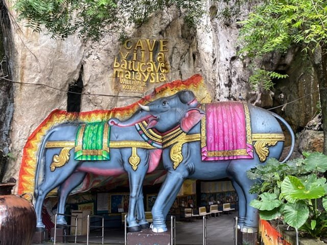 An elephant and a bull with their heads combined