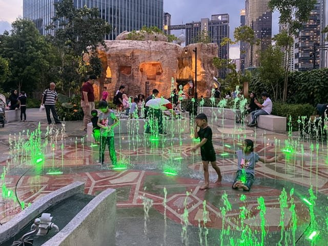 Children enjoying fountains in a play area