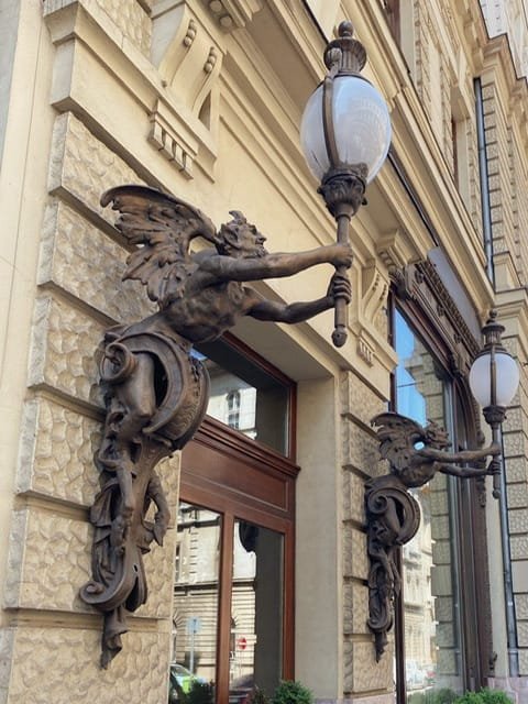 Two winged figures holding lights