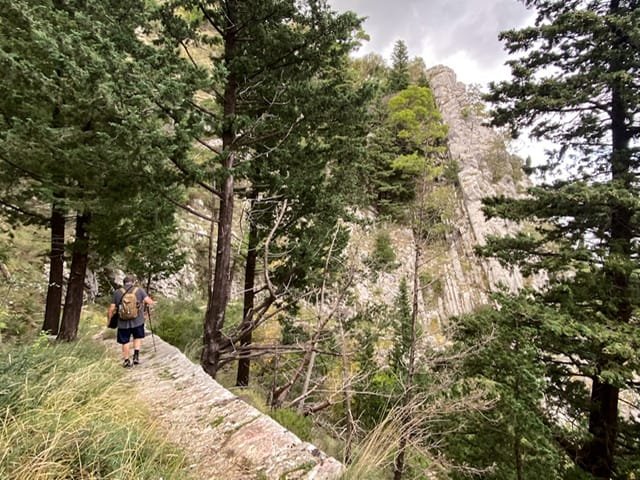 A man hiking along a ledge