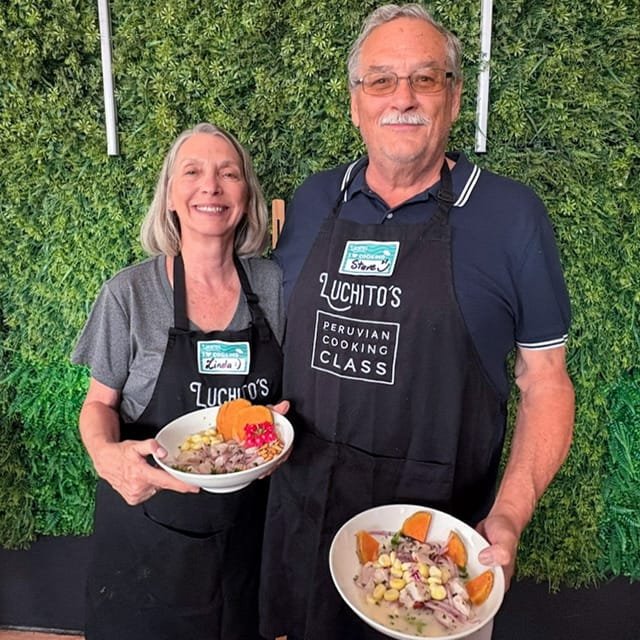A woman and a man holding bowls of ceviche