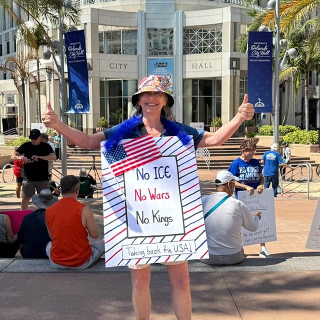 A woman holding a protest sign