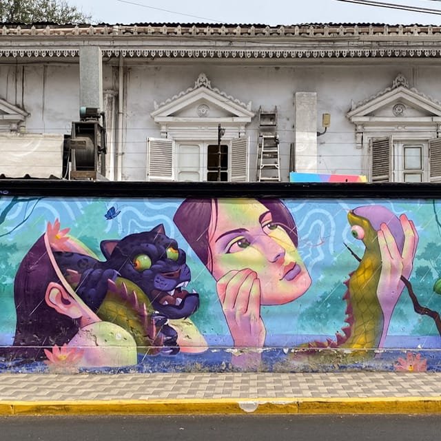 A mural with a leopard, a woman’s face, and a snake