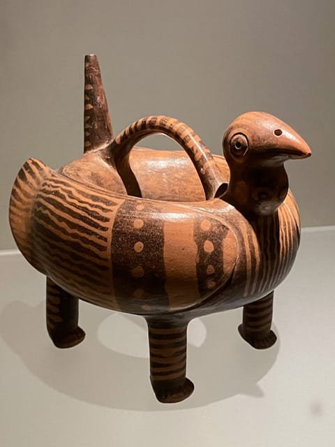 A figure with a bird’s head, the paws of a feline, and the body of a serpent